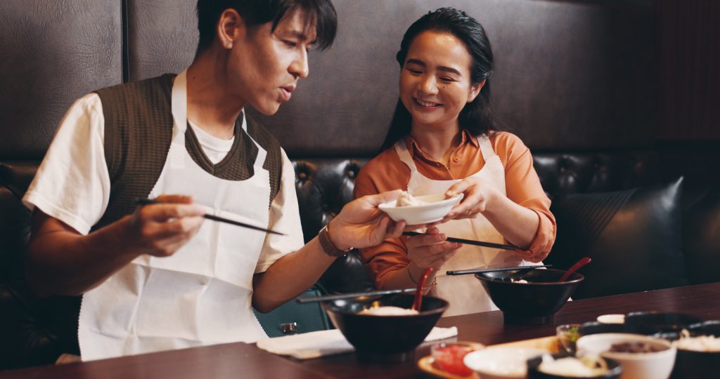 Asian couple sharing dinner